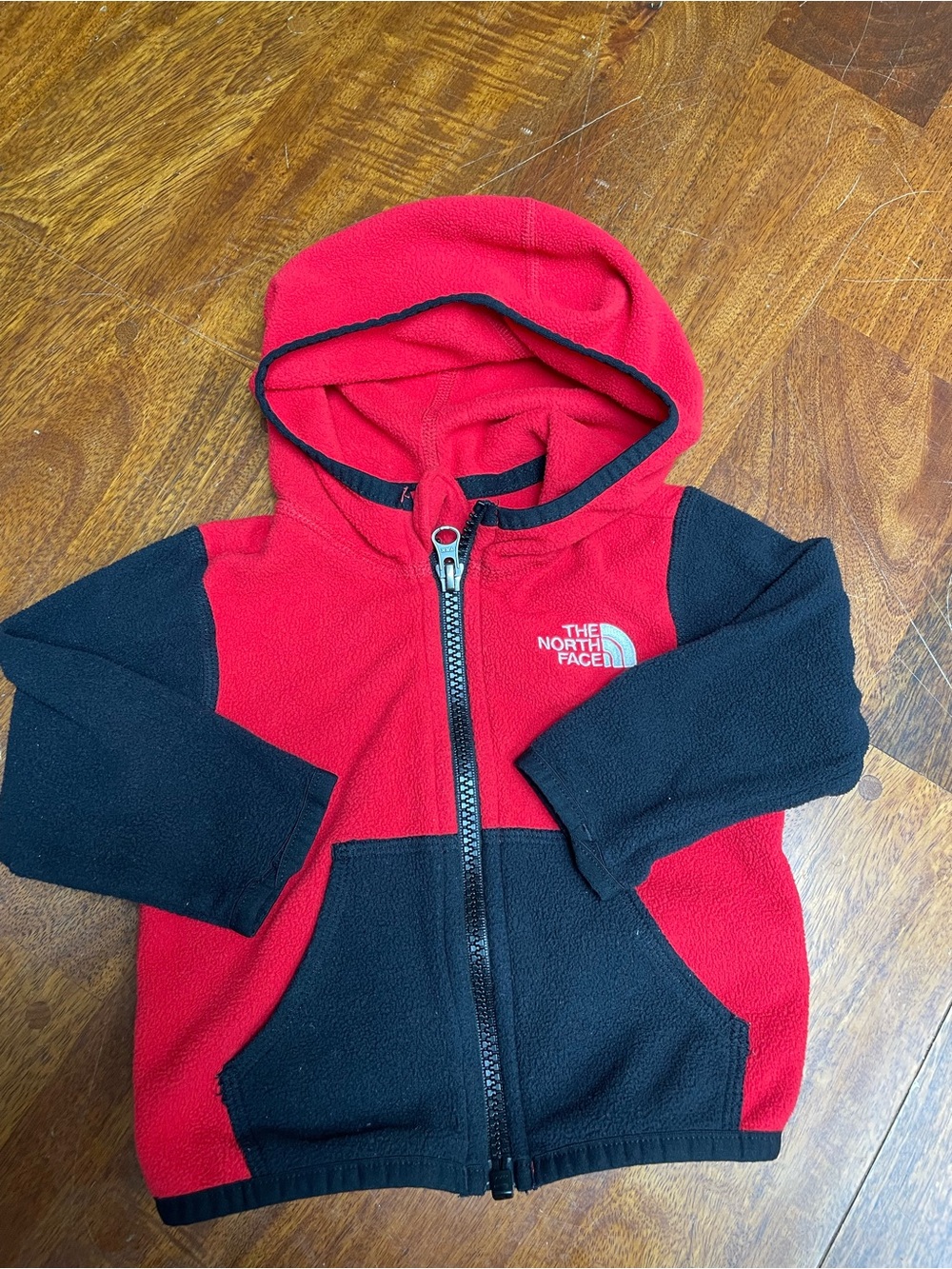 The north face red and black fleece zip up sweater size 3-6 months